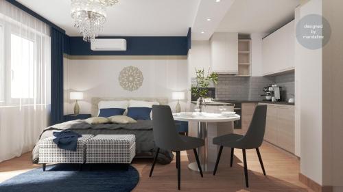 a bedroom with a bed and a table with chairs at Monarchia Apartman Sunny in Mosonmagyaróvár
