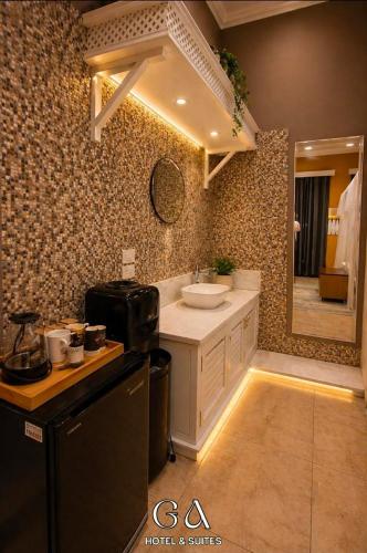 a bathroom with a sink and a counter with a mirror at GAP Cairo Hotel Downtown in Cairo