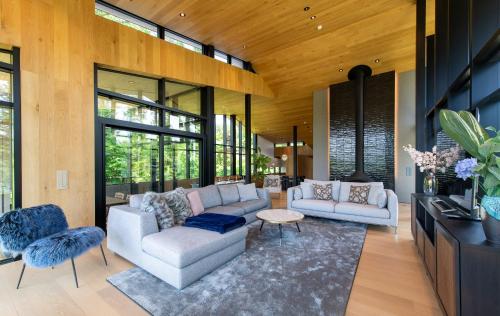 a living room with two couches and a table at Kazahana at Hanaridge in Kutchan