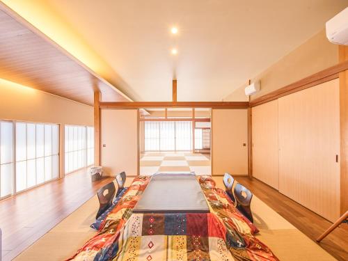a large room with a long table and chairs at 縁や出雲 in Taisha