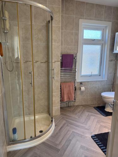 a bathroom with a shower and a toilet at Gillingham Hidden Gem in Gillingham
