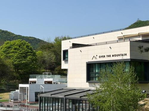 a building with a sign that reads out rift mountain at Over The Mountain in Gapyeong