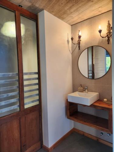 a bathroom with a sink and a mirror at La Choza - Refugio para dos in La Falda