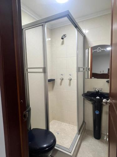 a bathroom with a shower and a toilet and a sink at Hotel Sabana Hilton in Madrid