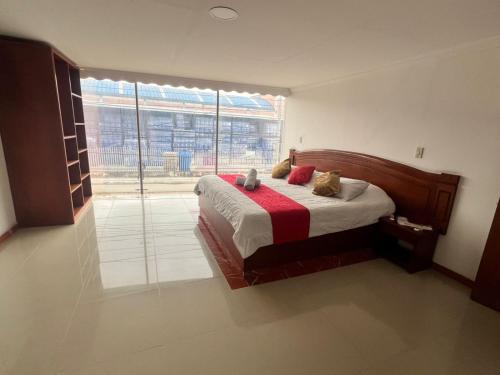 a bedroom with a bed and a large window at Hotel Sabana Hilton in Madrid
