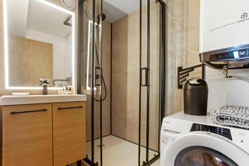 a bathroom with a washing machine and a sink at Moréa - residence avec piscine in Fréjus