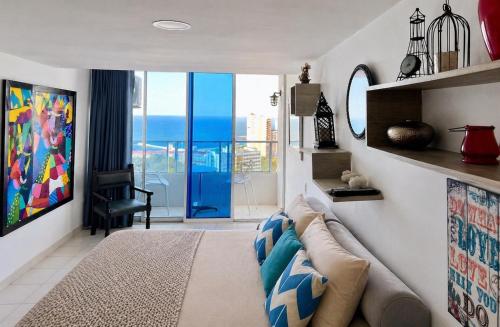 a living room with a couch and a view of the ocean at Loft playa y mar in Cartagena de Indias