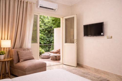 a room with a chair and a television on a wall at Hur palace pyramids view in Cairo
