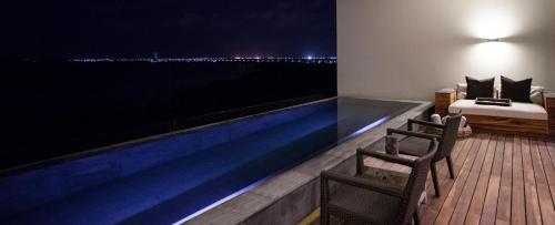 a hotel room with a swimming pool at night at NIZUC Resort & Spa in Cancún