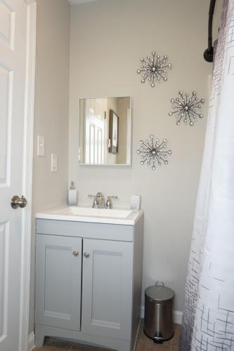 a bathroom with a white sink and a mirror at Gateway Getaways in Hagerstown
