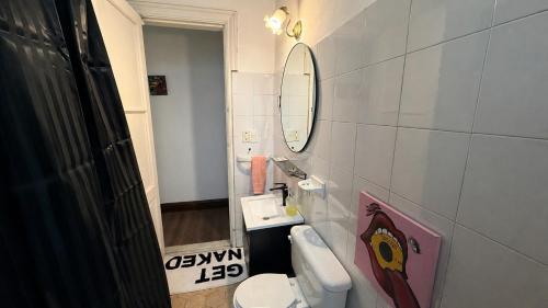 a bathroom with a sink and a toilet and a mirror at Home lab studio in Córdoba