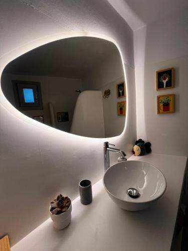 a bathroom with a sink and a mirror at Tzia Blue in Koundouros