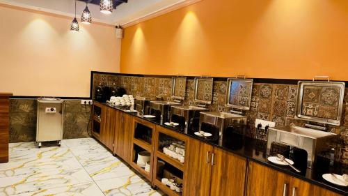 a restaurant with a counter with aasteryasteryasteryasteryasteryasteryasteryasteryastery at Bellavista Resort Munnar in Munnar