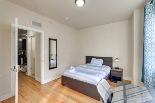 a bedroom with a bed and a table in it at Private Room | Temple | Fast WiFi | Kitchen V in Philadelphia