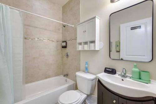 a bathroom with a toilet and a sink and a mirror at Private Room | Temple | Fast WiFi | Kitchen V in Philadelphia
