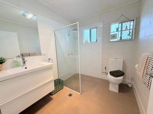 a bathroom with a shower and a toilet and a sink at 'Your Place on Davidson' Uno in Mount Isa