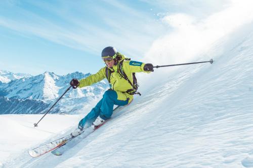 a person is skiing down a snow covered slope at Apart Garni Elfrieda in Ischgl