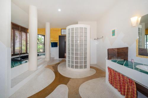 a bathroom with a sink and a mirror at Nature's Hill side Phana House in Phuket