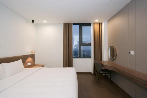 a hotel room with a bed and a desk at Prime Hotel in Thái Nguyên