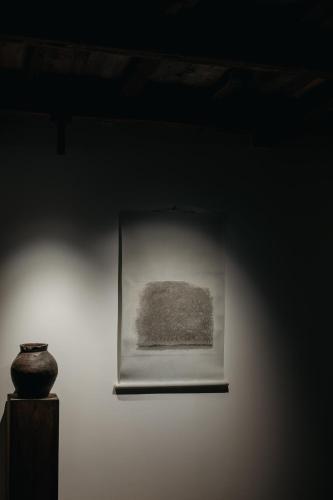 a painting on a wall with a vase on a table at Haku-ma 白間 in Kanazawa