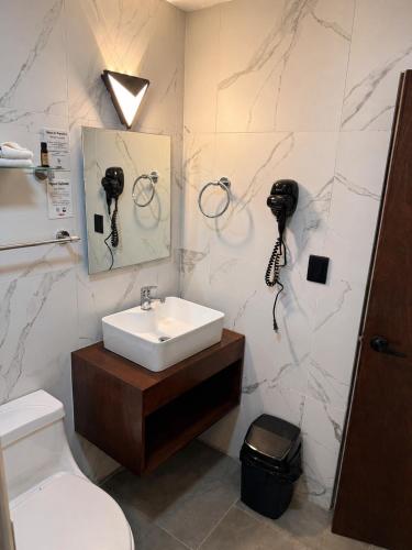 a bathroom with a sink and a toilet at El Suburbio - Aldama in Morelia