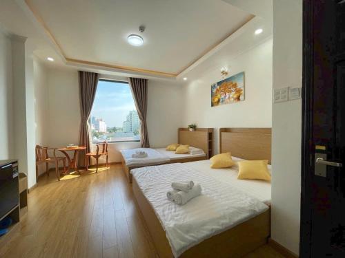 a bedroom with two beds with stuffed animals on them at VICTORIA hotel in Can Tho
