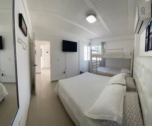a bedroom with a bed and a television in it at Sashii Hostel & Boutique. in Ríohacha
