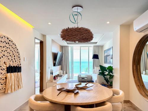 a living room with a round table and chairs at Hear the Waves Luxury Oceanfront Escape in Bucerías