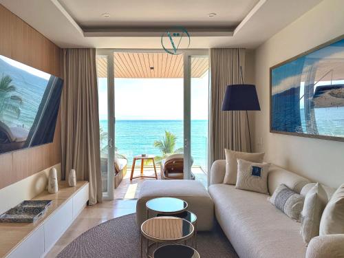 a living room with a couch and a view of the ocean at Hear the Waves Luxury Oceanfront Escape in Bucerías