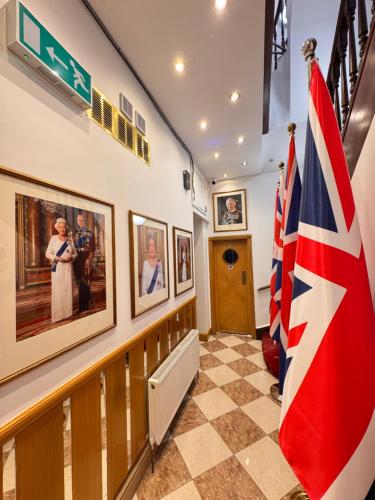 a hallway with a flag and pictures on the wall at Jubilee Hotel Kensington in London