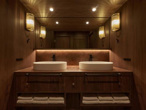 a bathroom with two sinks and a large mirror at illi Atra Aoyama in Tokyo