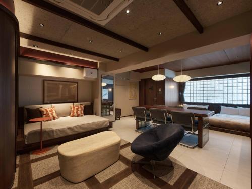 a bedroom with a bed and a dining room at illi Atra Aoyama in Tokyo