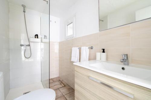 a bathroom with a shower and a toilet and a sink at Nafeti in Palma de Mallorca