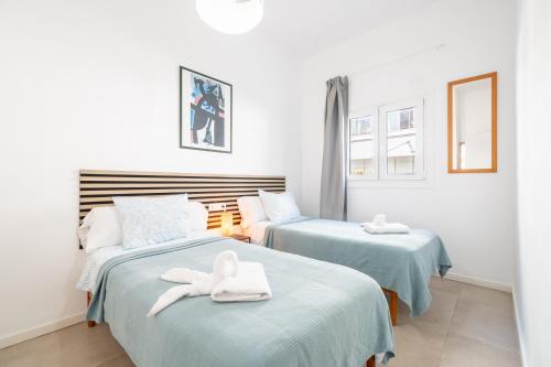two beds with towels on them in a room at Nafeti in Palma de Mallorca