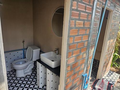 a bathroom with a toilet and a sink at Nomad Guesthouse by Buntha in Phumĭ Réach Born (2)