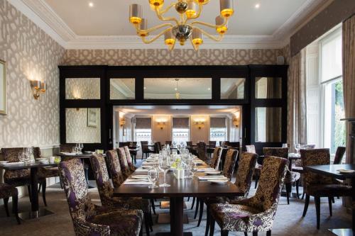 a dining room filled with tables and chairs at Trout Hotel in Cockermouth
