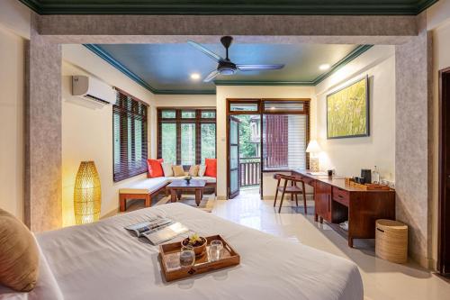 a bedroom in a villa with a bed and a desk at Semana Residences by Cove in Ubud