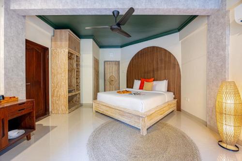 a bedroom with a bed and a ceiling fan at Semana Residences by Cove in Ubud