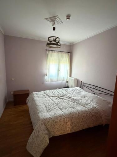 a bedroom with a bed and a window at Renas' Apartments in Chios island in Chios