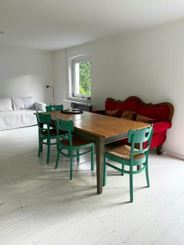 a living room with a wooden table and chairs at House Between Forest And Fields In Brandenburg in Casekow