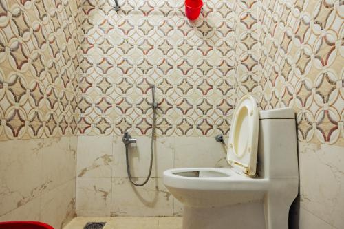 a bathroom with a toilet and a shower at Aanand Hotel in Janakpur