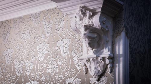a wall with a carving of a face on a wall at Trout Hotel in Cockermouth