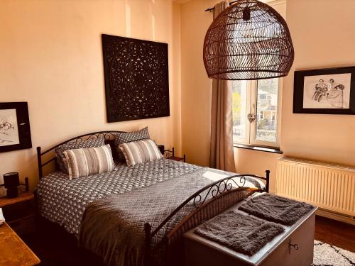 a bedroom with a bed and a window at La mosane in Profondeville
