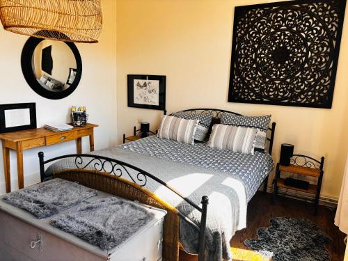 a bedroom with a bed and a mirror on the wall at La mosane in Profondeville