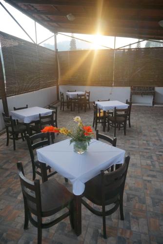 a group of tables and chairs with flowers on them at Hotel & Restaurant Fleur de Lis in Concepción de Ataco