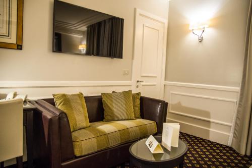 a living room with a couch and a table at Grand Hotel Sitea in Turin