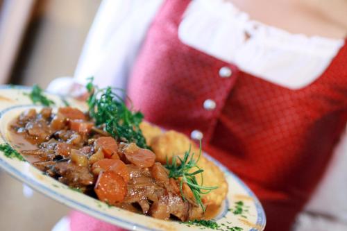 a plate of food with meat and vegetables on a plate at Gasthof zum Hammer in Göstling an der Ybbs