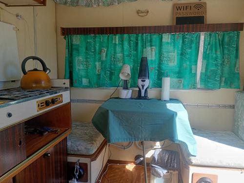 a small room with a table with a kettle on it at Yupfssi camp in Riga