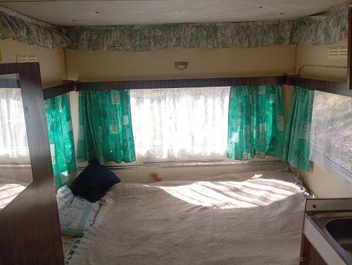 a small room with a bed and a window at Yupfssi camp in Riga