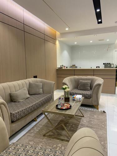 a living room with two couches and a coffee table at رُقيّ للشقق الفندقية rogy VIP in Taif
